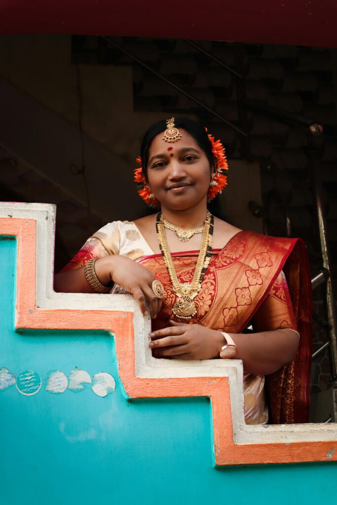 A beautiful Indian woman in a traditional sari, adorned with jewelry, captured during a local festival.